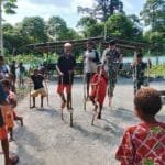 Asyiknya Permainan Tradisional, Satgas Yonif 310/KK Bersama Anak Papua Bermain Egrang WhatsApp Image 2024 06 15 at 09.50.08